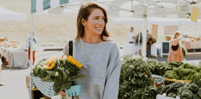 Catherine at fresh markets holding flowers